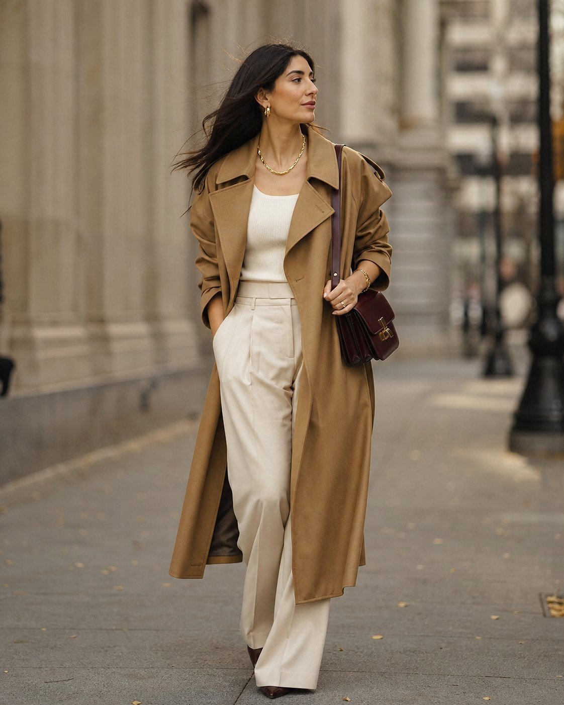 Street-style look with a camel trench coat, cream outfit and burgundy shoulder bag